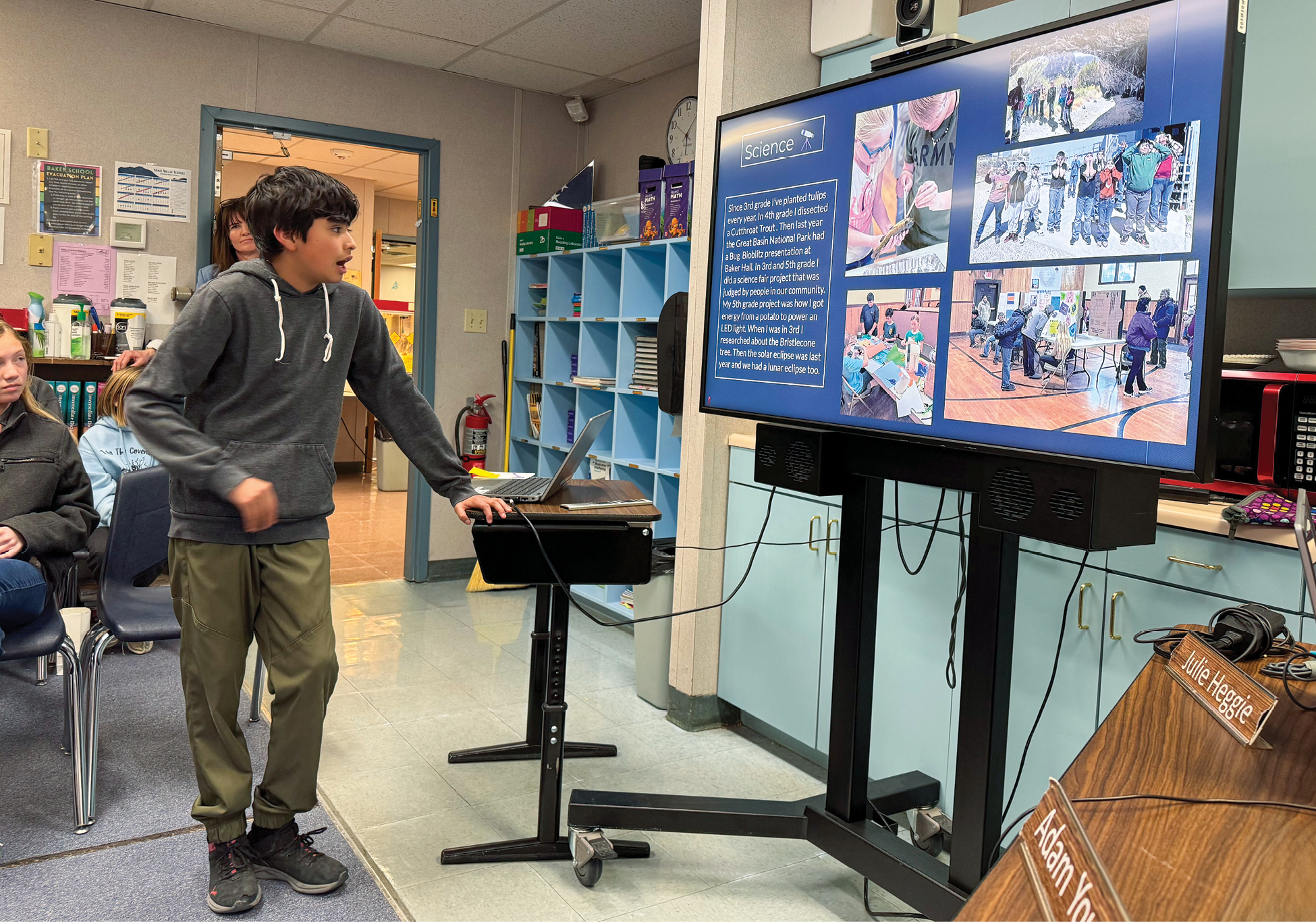 student standing at screen presenting