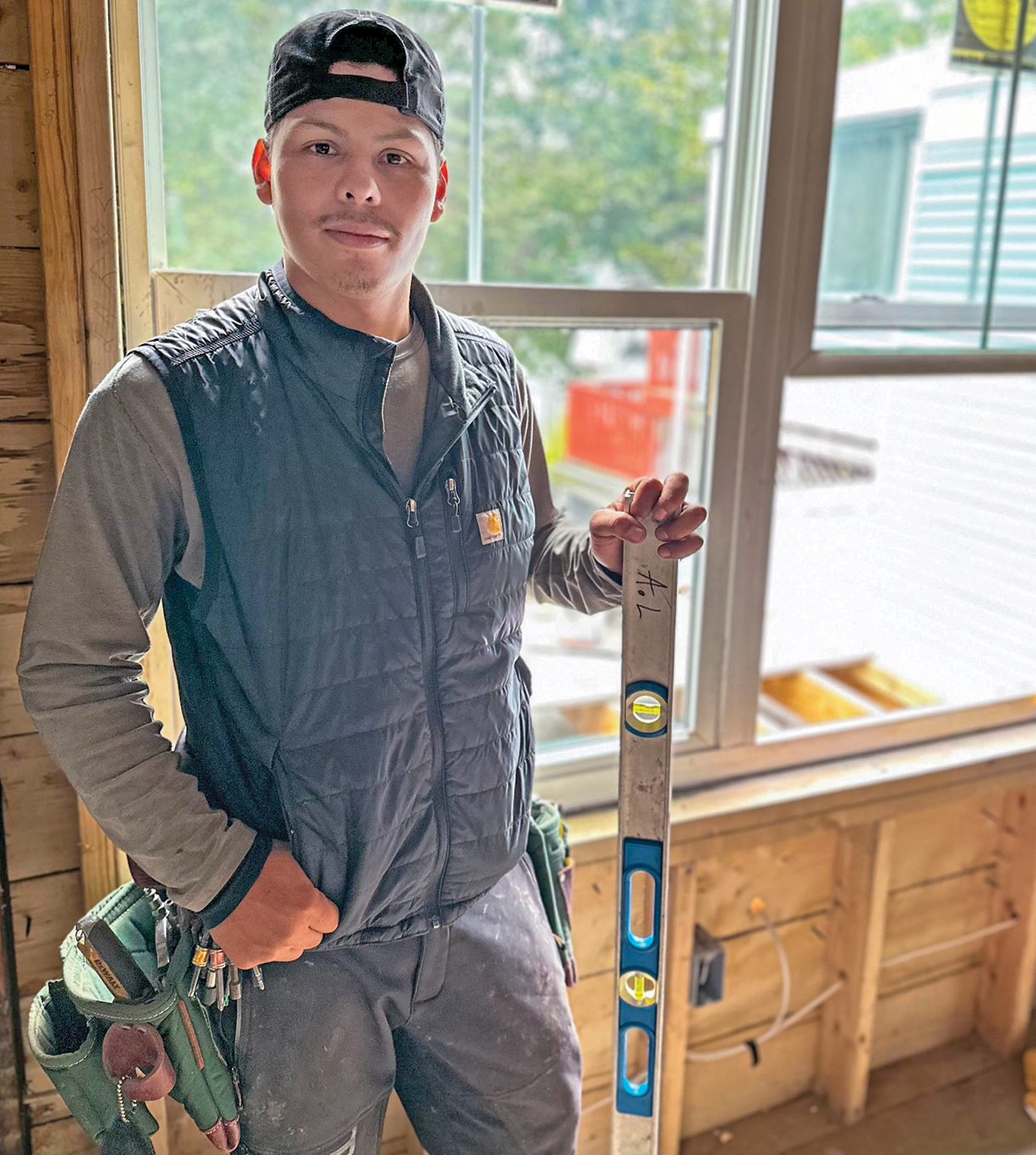 A man standing in a vest in a construction site