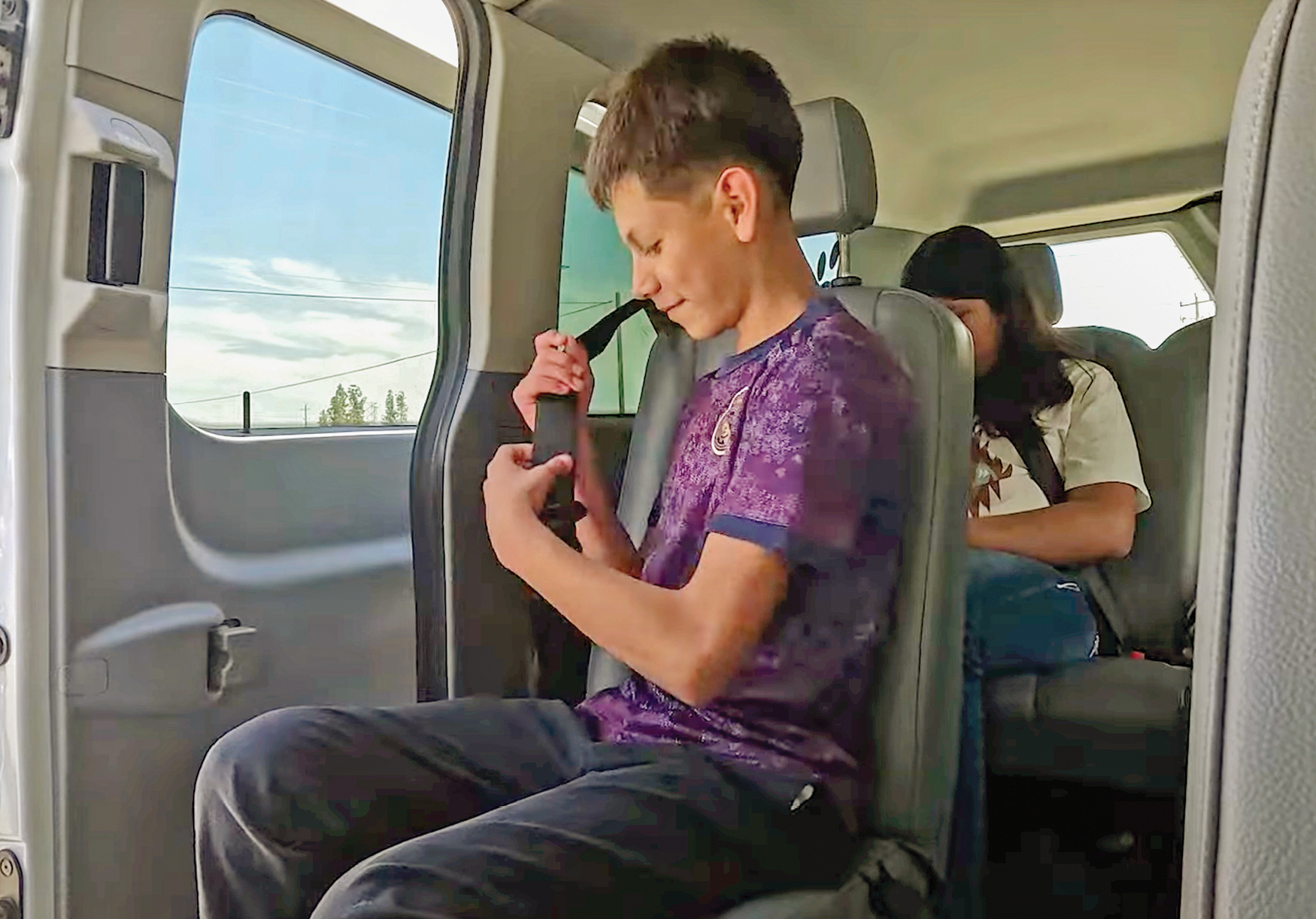 Students being driven to school in a van