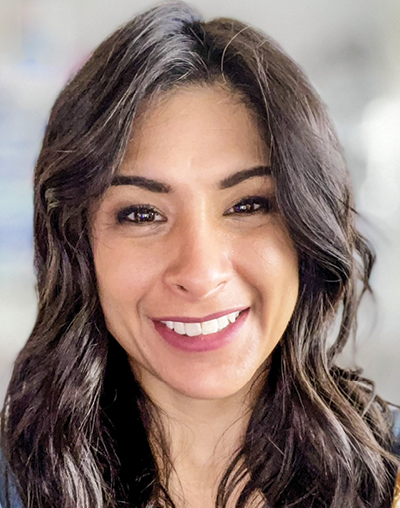 A white woman with brown hair smiling headshot