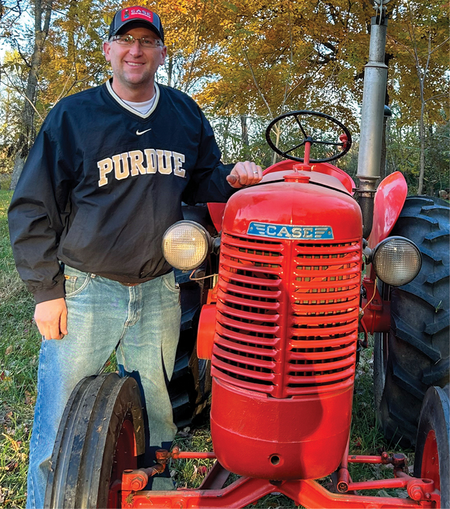 man standing with tractor