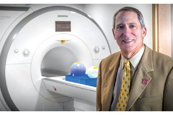 Dennis Molfese in front of MRI machine