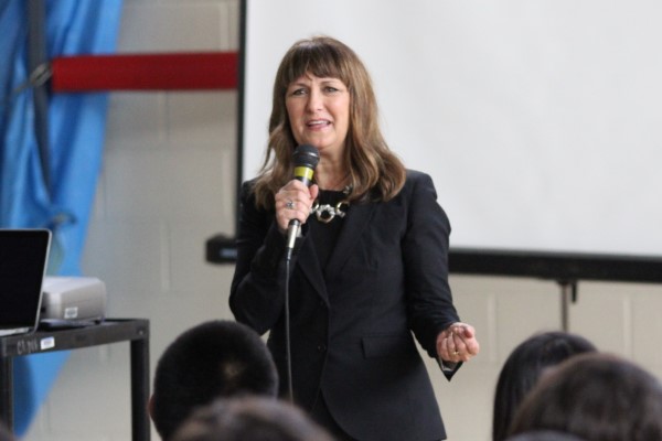 Kimberly Schonert Reichl speaks into a microphone