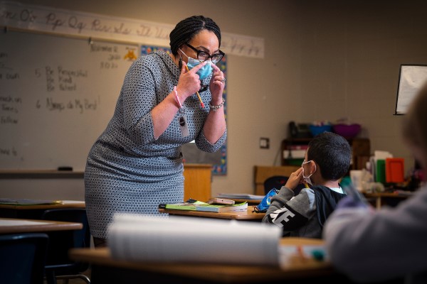 Sharon Contreras with a mask on instructing a student