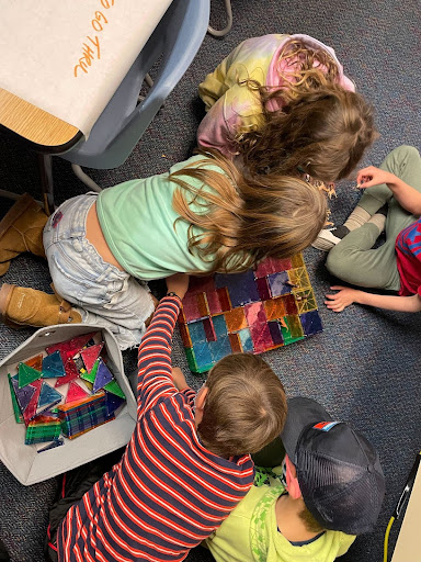 Students reenact the destruction of the fires to their homes by building houses out of magnatiles and knocking them down.