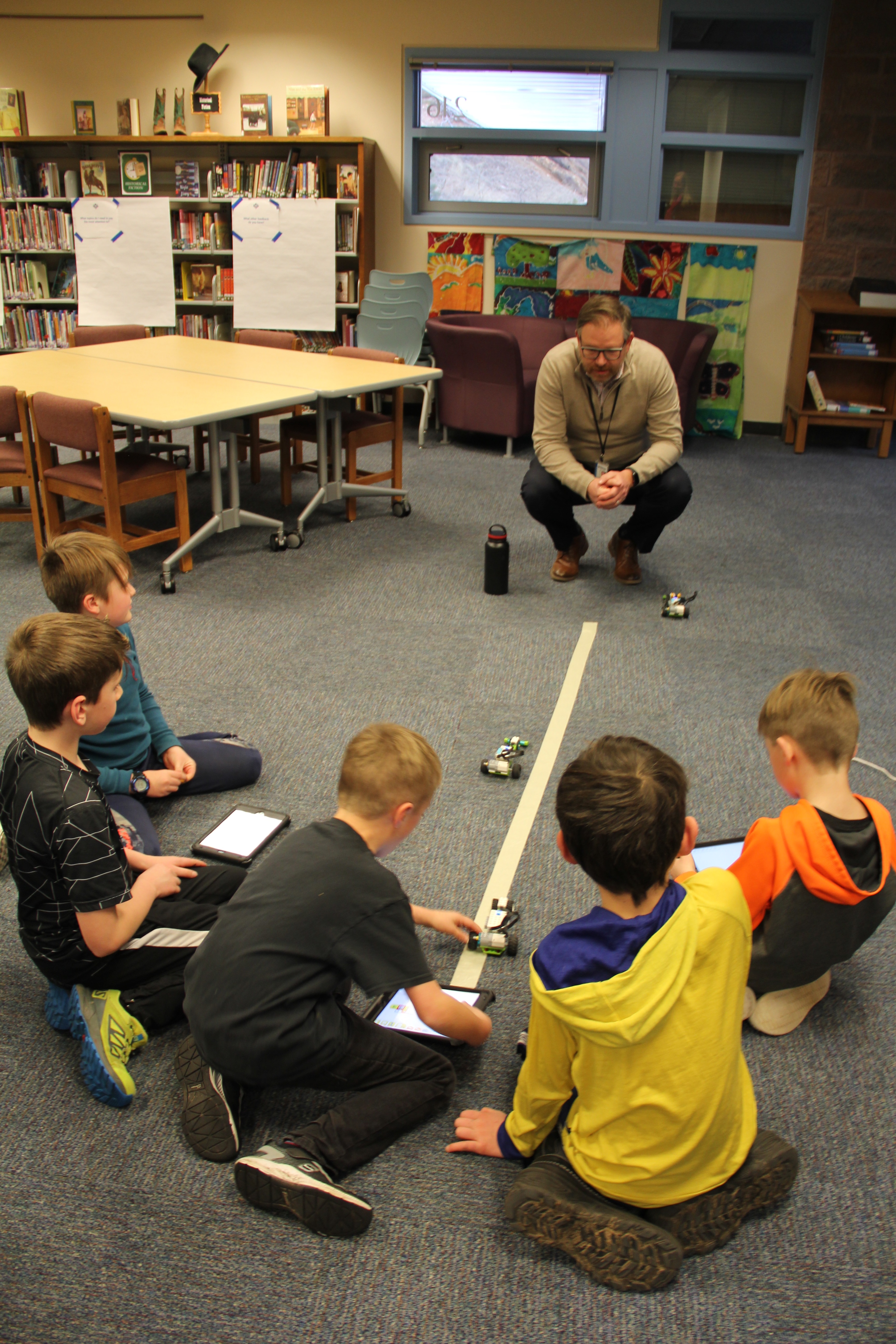 Superintendent Rob Anderson speaks to Nederland Elementary students about their robotic car races