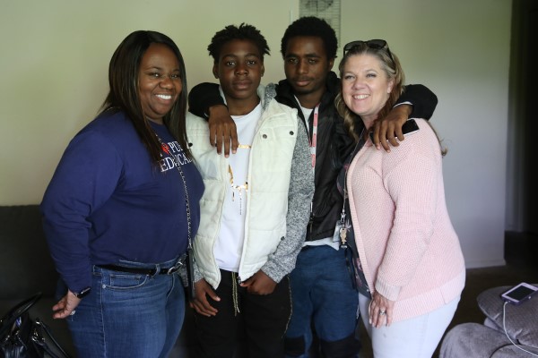 Travis Davis poses with three other folks for a photo
