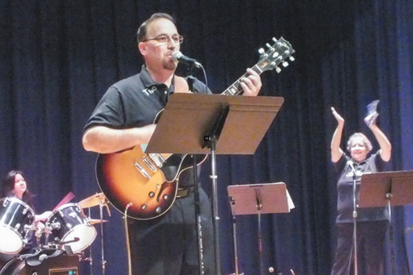 Joseph Famularo singing and playing guitar