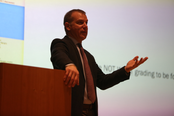 Joe Feldman gives a presentation on stage