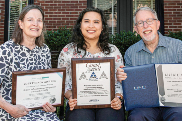 photo of School Administrator staff holding certificates and plaques of 2025 award wins